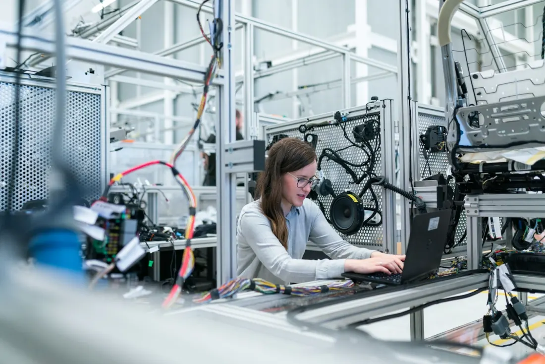 Professional in an industrial workplace reviewing technical systems
